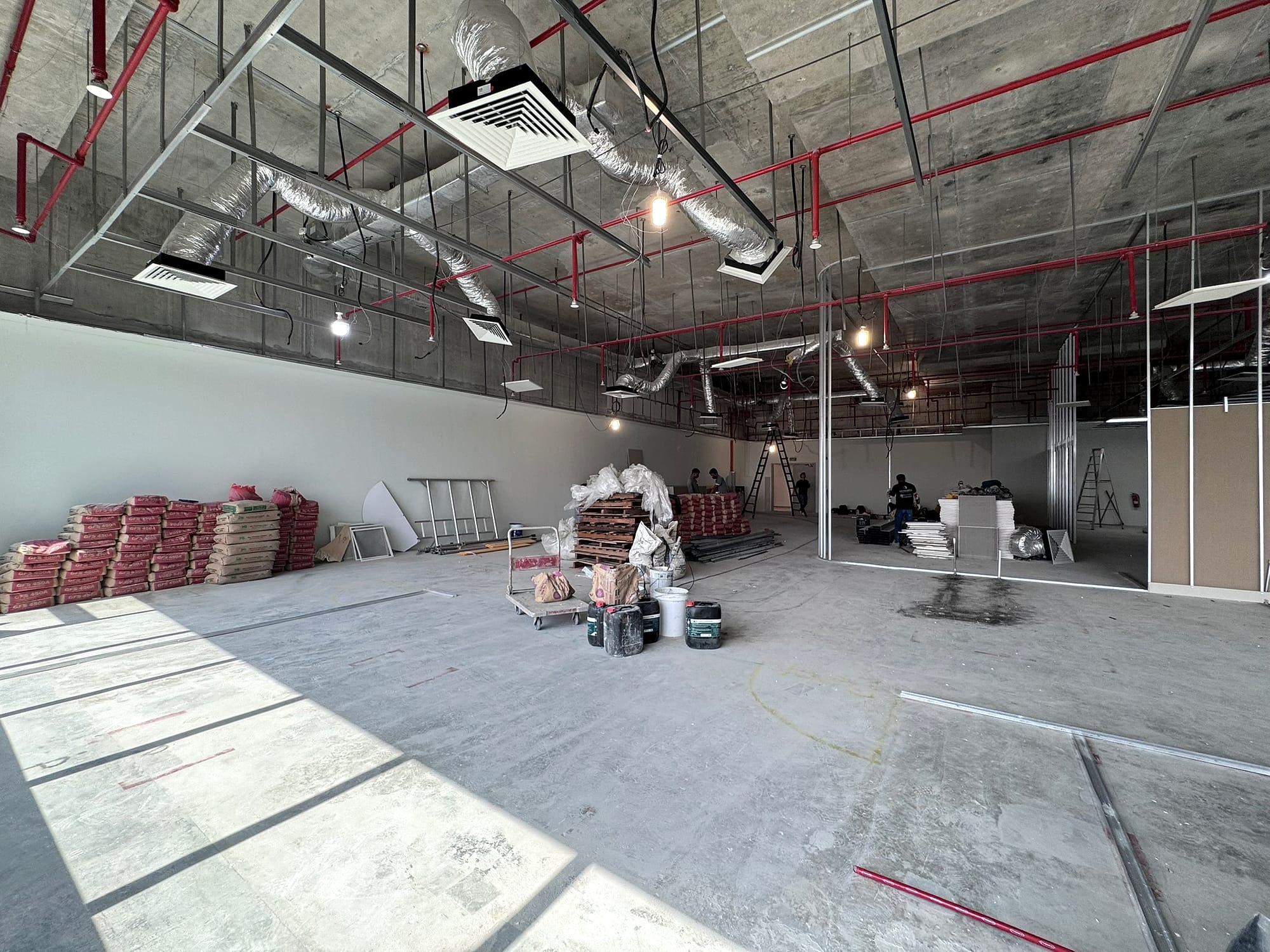 Insulated duct runs across an office shell space ceiling