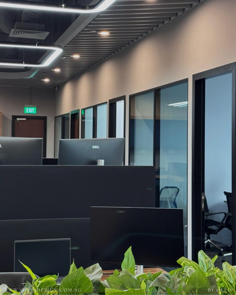 Completed open-plan office working area with glass-fronted rooms and ceiling