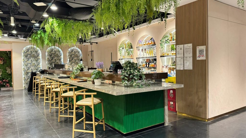 Completed restaurant bar and dining area with ceiling planting and lighting
